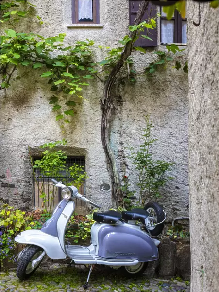 White and grey Lambretta Innocenti scooter in a courtyard, Morbegno, province of Sondrio