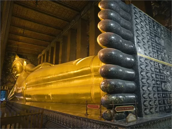 Thailand, Bangkok. Giant reclining Buddha statue at Wat Pho