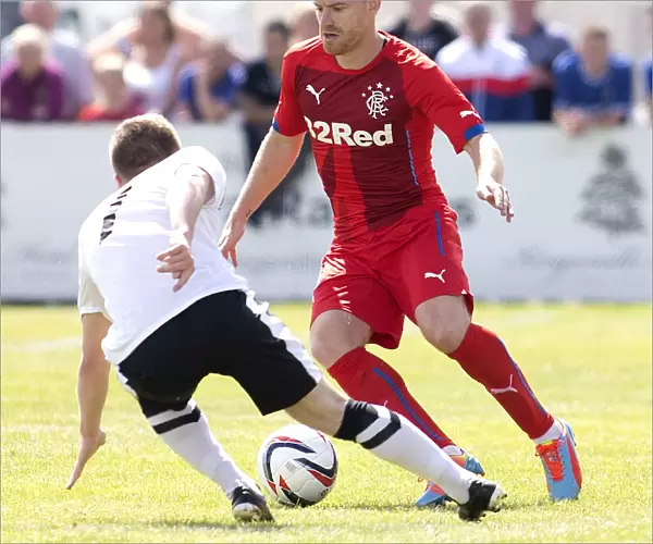 Stevie Smith of Rangers in Action Against Brora Rangers: Pre-Season Friendly Clash of Scottish Cup Champions