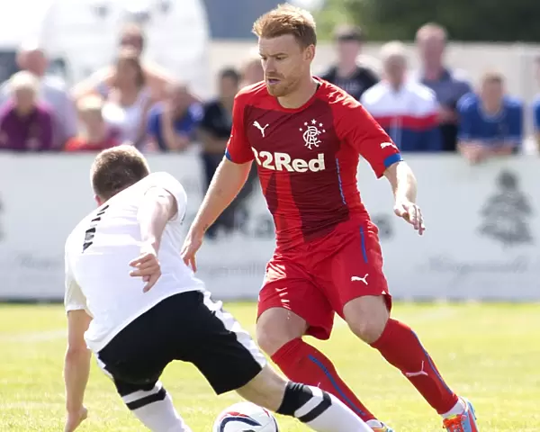 Stevie Smith of Rangers in Action Against Brora Rangers: Pre-Season Friendly Clash of Scottish Cup Champions