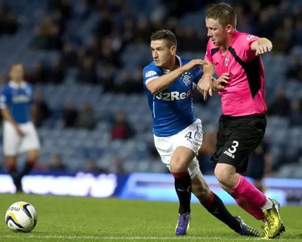 Intense Rivalry: Fraser Aird vs Ross McKinnon - A Pivotal Moment at Ibrox Stadium during the Petrofac Training Cup Second Round