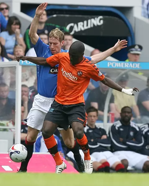 Intense Battle for the Ball: Kirk Broadfoot vs Morgaro Gomis at Ibrox - Rangers 3-1 Victory