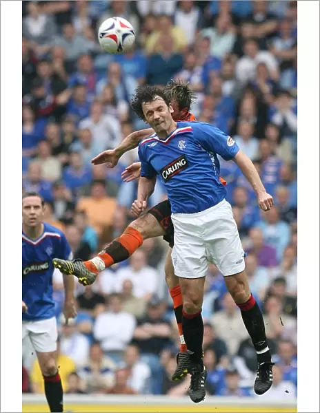 Intense Rivalry: Christian Dailly vs Noel Hunt - A Battle for the Ball at Ibrox (Rangers 3-1 Dundee United)