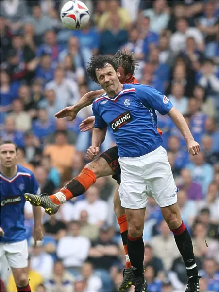 Intense Rivalry: Christian Dailly vs Noel Hunt - A Battle for the Ball at Ibrox (Rangers 3-1 Dundee United)