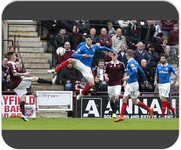 Rangers Haris Vuckic Leaps for the Ball in Intense Scottish Championship Clash vs. Heart of Midlothian at Tynecastle Stadium