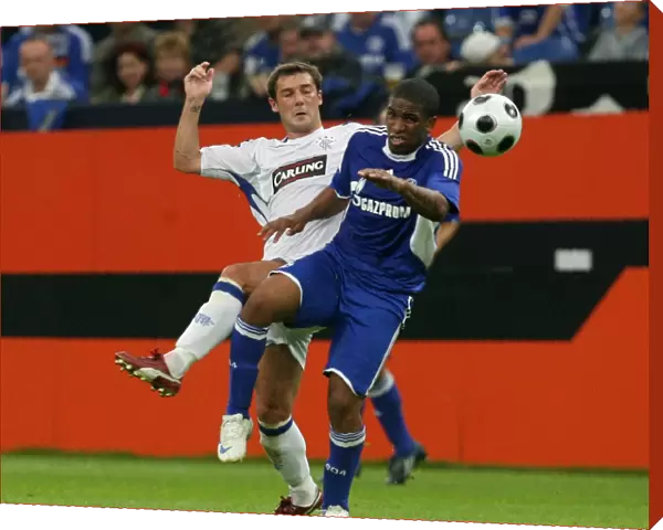Rangers vs. Schalke 04: Intense Clash Between Jefferson Farfan and Kevin Thomson at Veltins Arena (Schalke Leads 1-0)