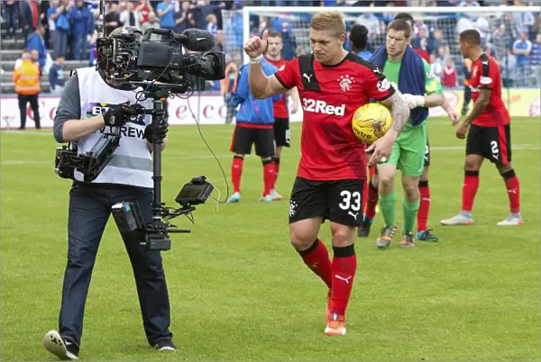 Rangers Championship Victory: Martyn Waghorn Celebrates with Match Ball at Cappielow Park