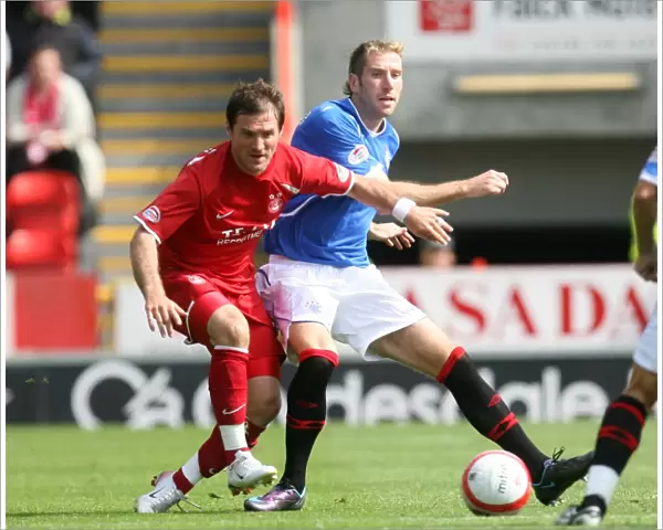 Aberdeen vs Rangers: A Tie at Pittodrie - Clash between Kirk Broadfoot and Jamie Smith in Clydesdale Bank Premier League Soccer