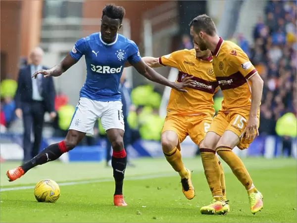 Rangers Joe Dodoo Protects the Ball at Ibrox Stadium during Scottish Premiership Match vs Motherwell
