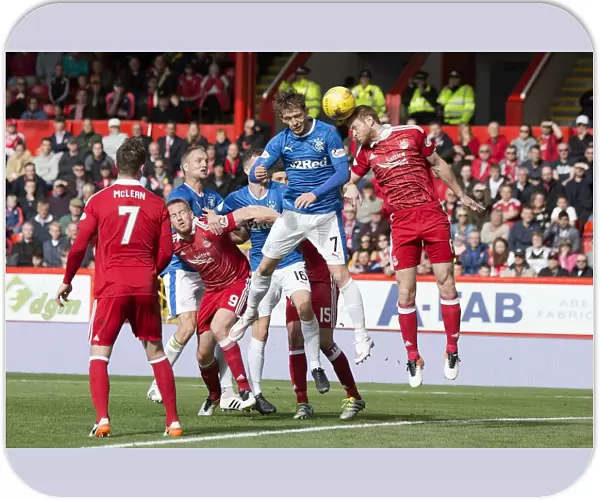 Rangers Joe Garner Clashes Heads with Aberdeen's Mark Reynolds: Aerial Battle at Pittodrie Stadium