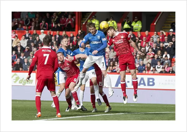 Rangers Joe Garner Clashes Heads with Aberdeen's Mark Reynolds: Aerial Battle at Pittodrie Stadium