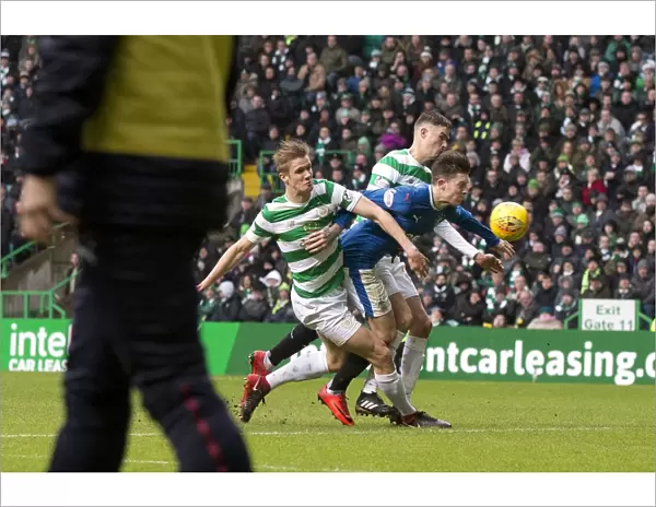 Rangers Windass Sandwiched by Celtic Defenders Ajer and Lustig in Intense Premiership Clash