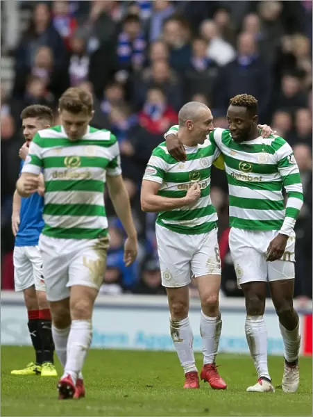 Celtic's Celebration: Dembele and Brown Rejoice at Ibrox after Goal in Rangers vs Celtic Match