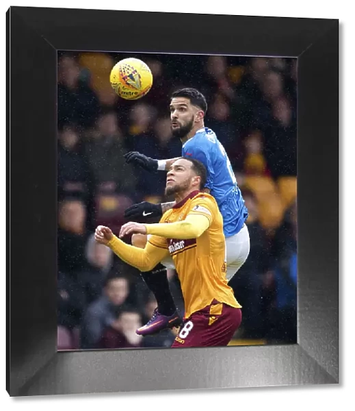 Clash at Fir Park: Leaping Duel between Rangers Daniel Candeias and Motherwell's Charles Dunne