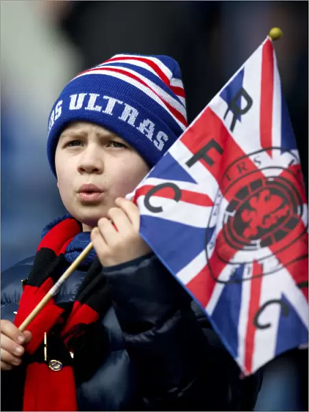Young Rangers Fan Waving Union Jack at Ibrox: Passionate Support Amidst Rangers vs Dundee Match