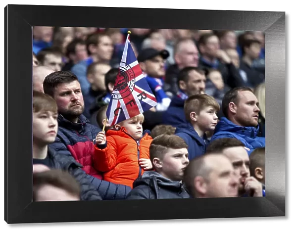 Passionate Young Rangers Fan Waving Union Jack at Ibrox Stadium during Rangers vs Dundee Match