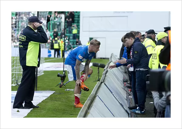 Rangers Jason Cummings: A Heartfelt Gift to Fans - Handing Over His Boots During the Hibernian Clash (Scottish Premiership 2021)