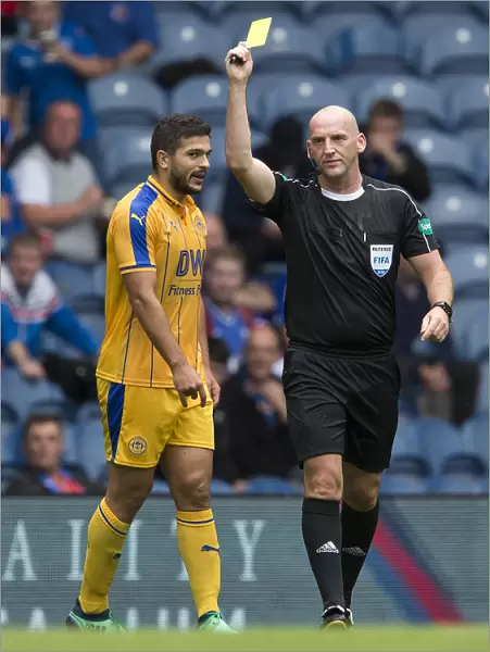 Referee Bobby Madden Shows Yellow Card to Samy Morsy during Rangers vs Wigan Athletic Match at Ibrox Stadium