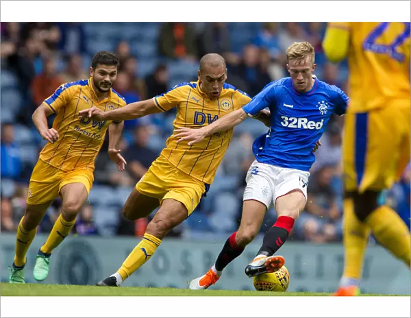 Rangers Ross McCrorie Defends Against Wigan's James Vaughn in Pre-Season Clash at Ibrox Stadium