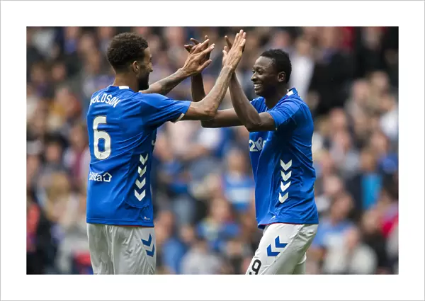 Rangers Goldson and Sadiq in Triumph: Celebrating the Third Goal vs Wigan Athletic at Ibrox Stadium