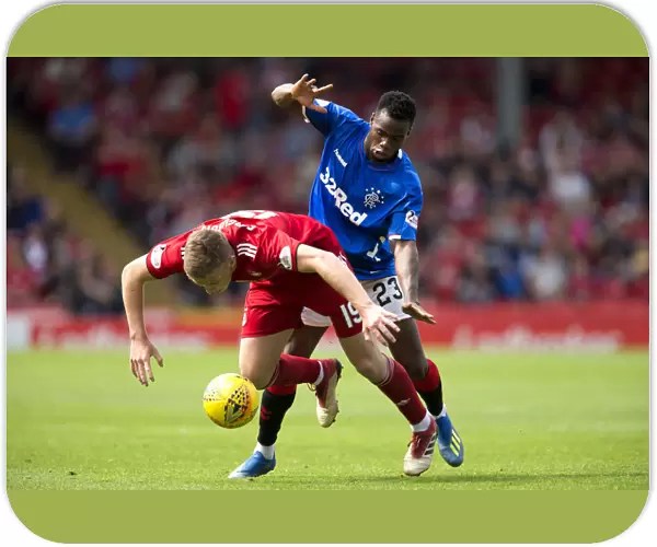 Rangers vs Aberdeen: Lassana Coulibaly Fouls Lewis Ferguson in Intense Ladbrokes Premiership Clash at Pittodrie Stadium