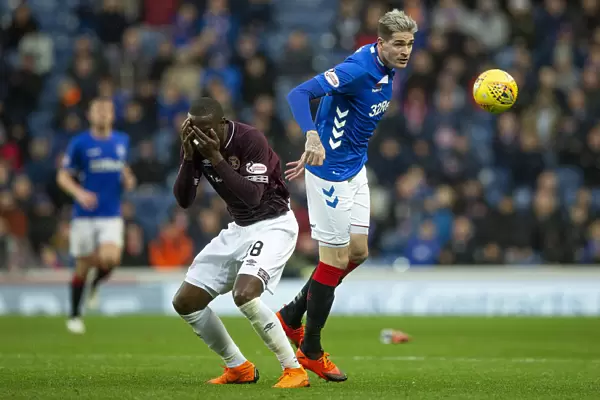 Rangers vs Hearts: Kyle Lafferty Leaps for the Ball in the Ladbrokes Premiership at Ibrox Stadium
