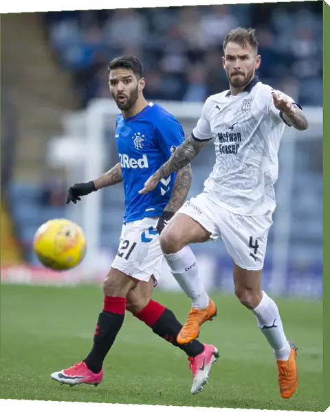 Clash at Dens Park: A Battle Between Rangers Daniel Candeias and Dundee's Martin Woods