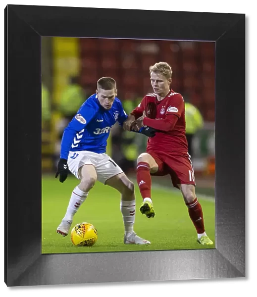 Rangers Ryan Kent Fends Off Aberdeen's Gary Mackay-Steven in Scottish Premiership Clash at Pittodrie Stadium