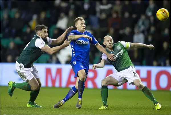 Rangers Scott Arfield Fends Off Hibernian Defenders McGregor and Gray during the Scottish Premiership Clash at Easter Road