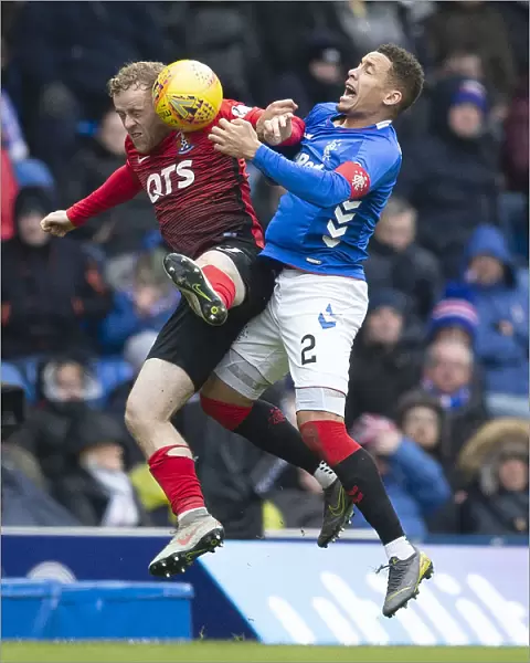Rangers vs Kilmarnock: Tavernier Leaps for the Ball in Scottish Premiership Action at Ibrox Stadium