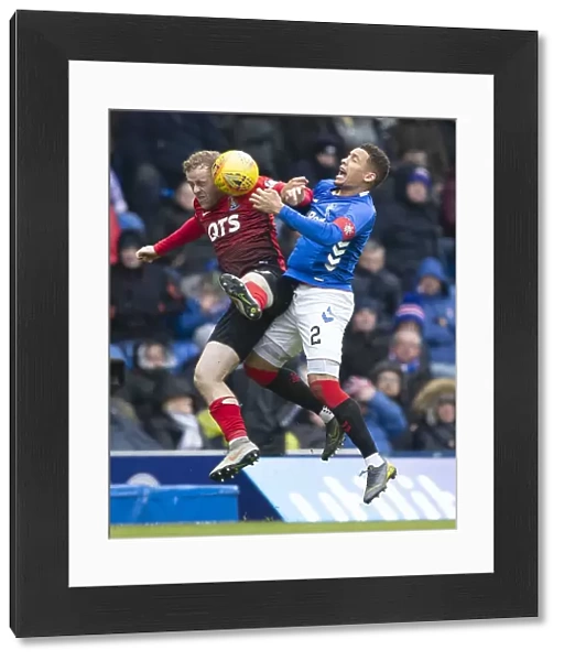 Rangers vs Kilmarnock: Tavernier Leaps for the Ball in Scottish Premiership Action at Ibrox Stadium