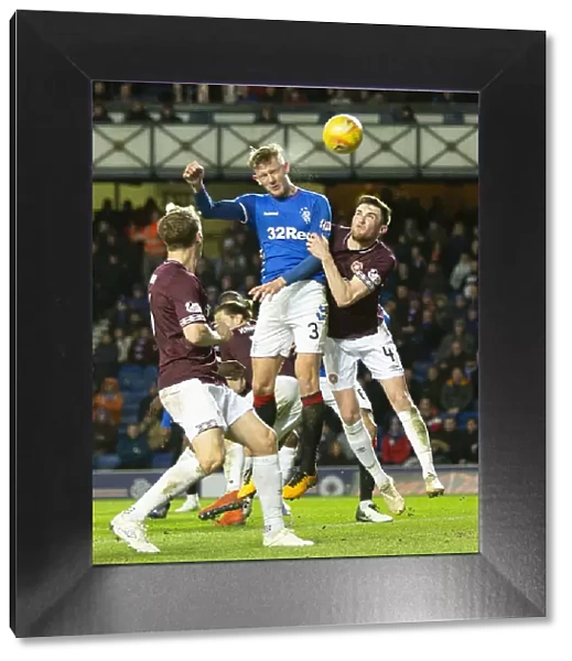 Rangers Joe Worrall Leaps High: Aerial Battle at Ibrox During Rangers vs Hearts (Scottish Premiership)
