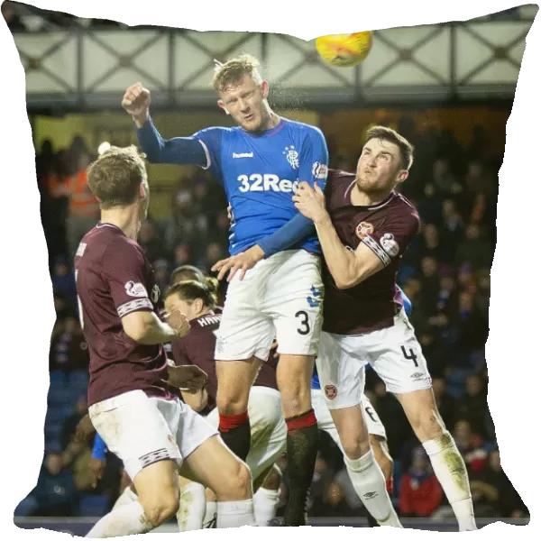 Rangers Joe Worrall Leaps High: Aerial Battle at Ibrox During Rangers vs Hearts (Scottish Premiership)