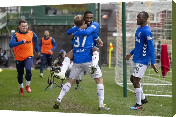 Triple Threat: Arfield and Defoe's Euphoric Celebration of Rangers Hat-Trick Against Motherwell