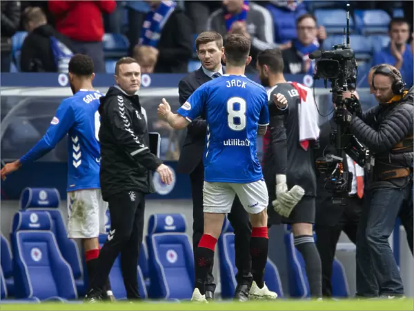 Champions Embrace: Steven Gerrard and Ryan Jack Share a Victory Handshake after Rangers Scottish Premiership Title Win
