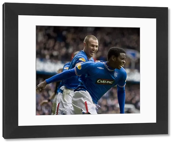 Rangers Maurice Edu Scores Game-Winning Goal Against Celtic: Euphoric Celebration with Kenny Miller (Clydesdale Bank Premier League)