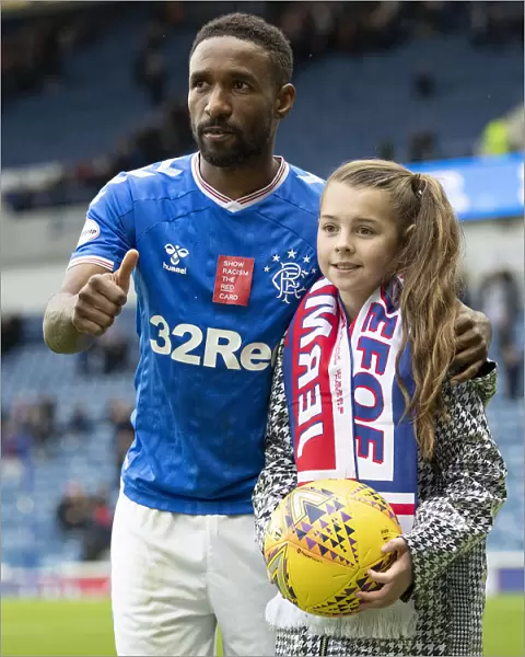 Rangers Defoe and Young Fan Share Unforgettable Hat-trick Moment at Ibrox Stadium