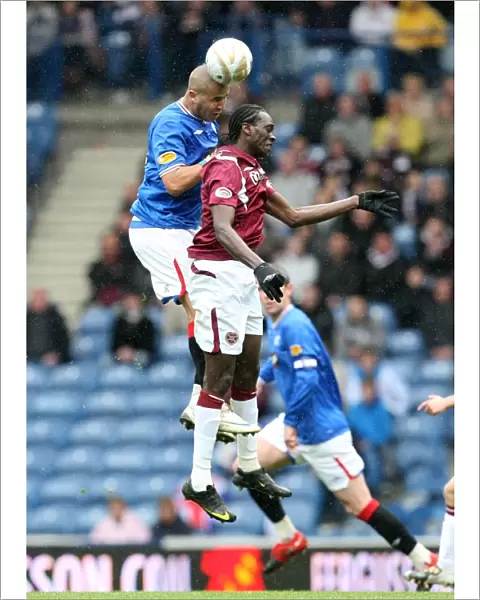 Intense Aerial Clash: Madjid Bougherra vs David Obua (Rangers 2-0 Hearts)
