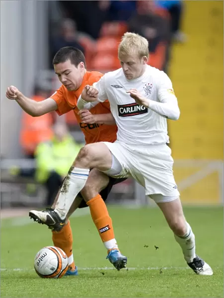 Rangers Naismith Snatches Crucial Ball from Dundee United's Dillon (1-2)