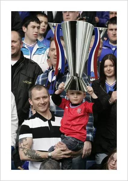 Rangers FC: SPL Champions - Triumphant Moment with the Trophy at Ibrox Stadium among Ecstatic Fans