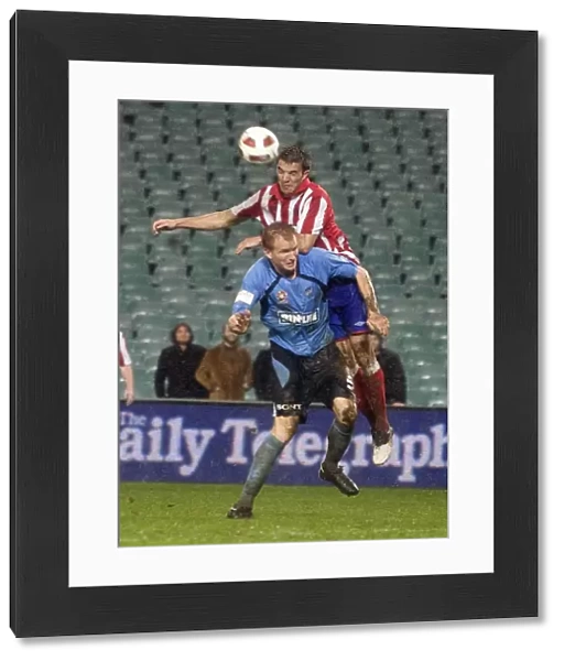 Rangers Andy Little Soars Over Sydney FC's Hayden Foxe: A Leap of Faith at the Sydney Festival of Football 2010