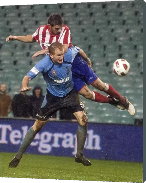 Rangers Andy Little Defies Sydney FC's Hayden Foxe: A Thrilling Leap at the Sydney Festival of Football 2010