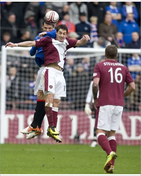 Leap of Triumph: Lee McCulloch Soars Over Rudi Skacel for a 1-0 Rangers Victory