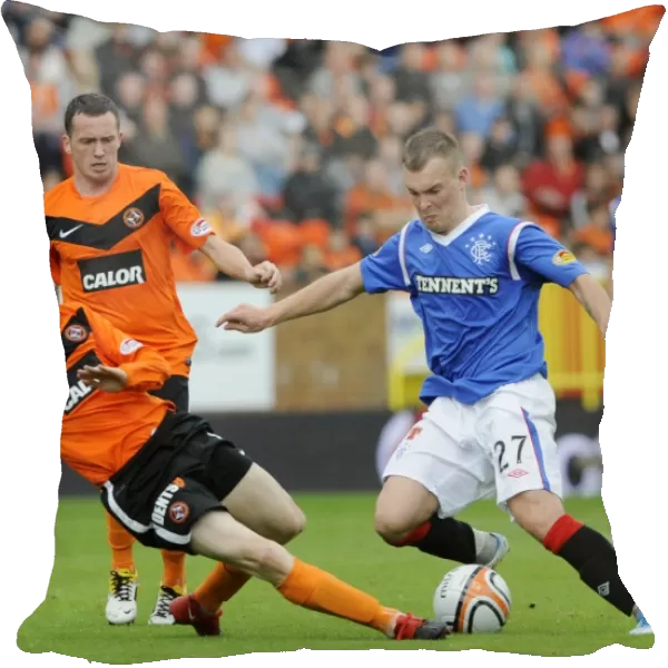 Rangers Wylde Faces Brutal Tackle from Dundee United's Flood in Intense Clydesdale Bank Scottish Premier League Clash