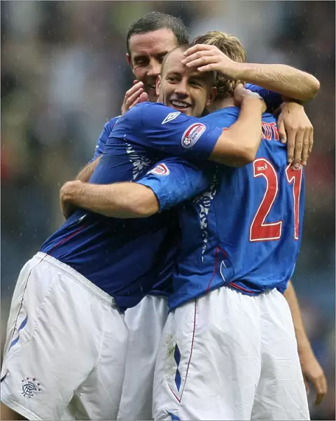 Rangers Alan Hutton, David Weir and Kirk Broadfoot: Triumphant Celebration After Broadfoot's Goal in Rangers 7-2 Victory Over Falkirk
