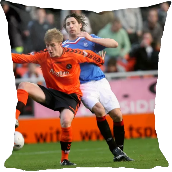 Dundee United's Jordan Robertson and Carlos Cuellar Clash in Intense Clydesdale Bank Premier League Match (2-1 in Favor of Dundee United)