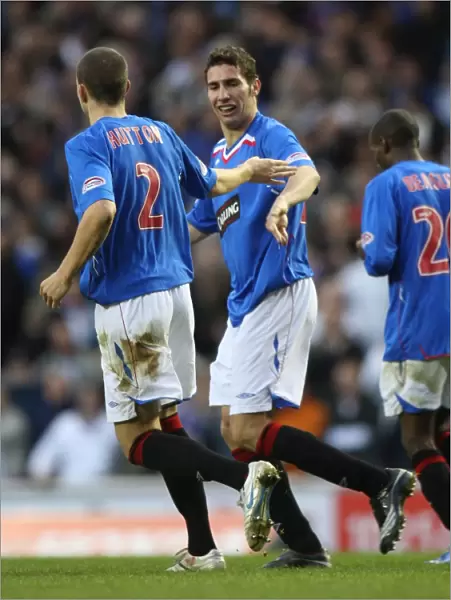 Rangers Carlos Cuellar and Alan Hutton: A Celebratory Moment after Scoring against Inverness Caledonian Thistle (2-0)
