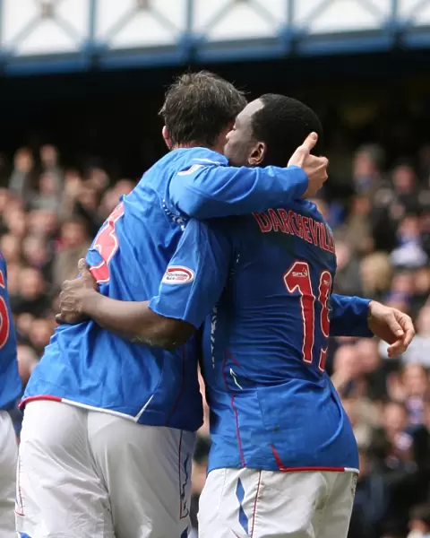 Rangers Darcheville and Weir: A Jubilant Moment as They Celebrate Goal Against Hibernian at Ibrox