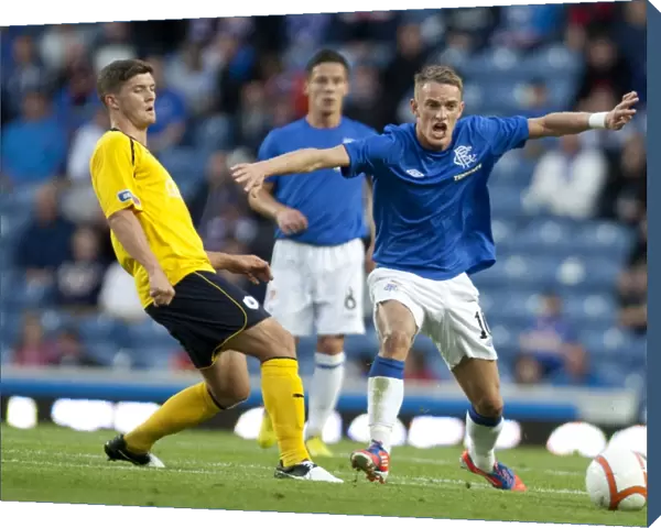 Rangers Triumph: Dean Shiels Scores the Decisive Goal in a 3-0 Scottish League Cup Victory over Falkirk at Ibrox Stadium