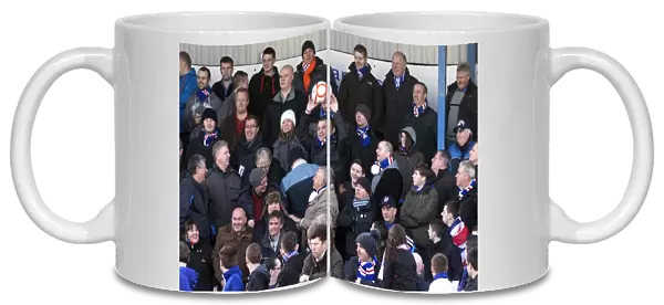 Rangers Fan's Triumph: Celebrating with the Match Ball after Montrose vs Rangers: 4-2 Victory